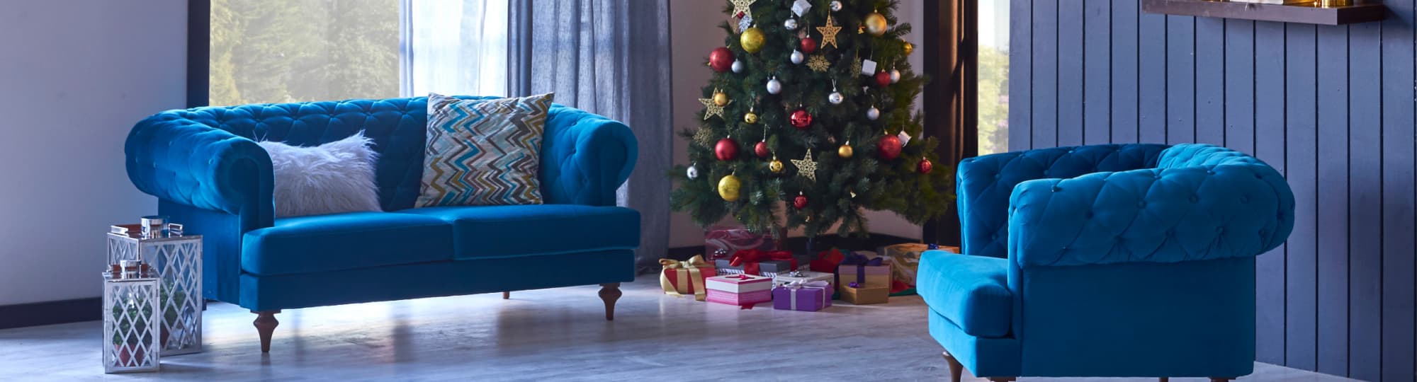 Blue sofa next to Christmas Tree