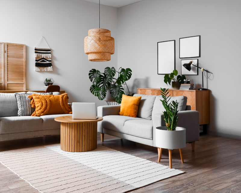 grey sofa with orange pillows blog
